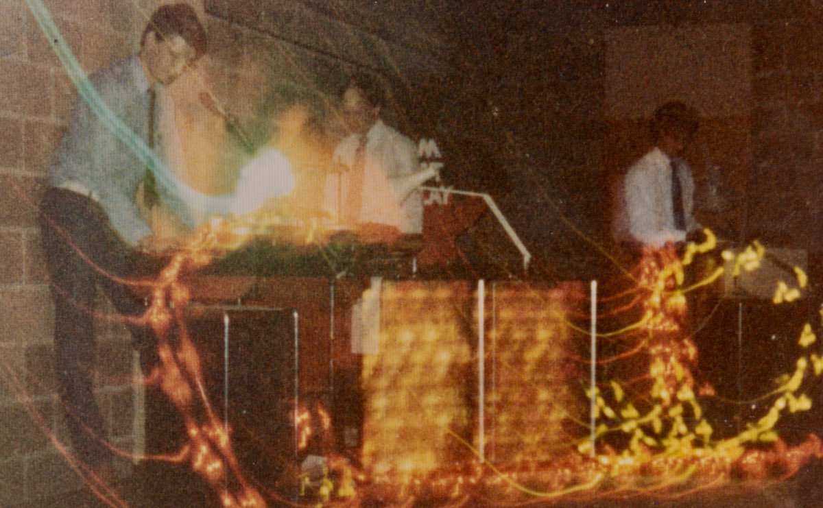 First Home Service gig - three people playing synths behind rope lights